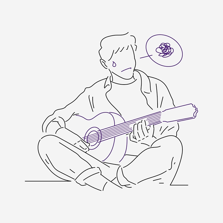 ギターの練習がうまくいかない男性